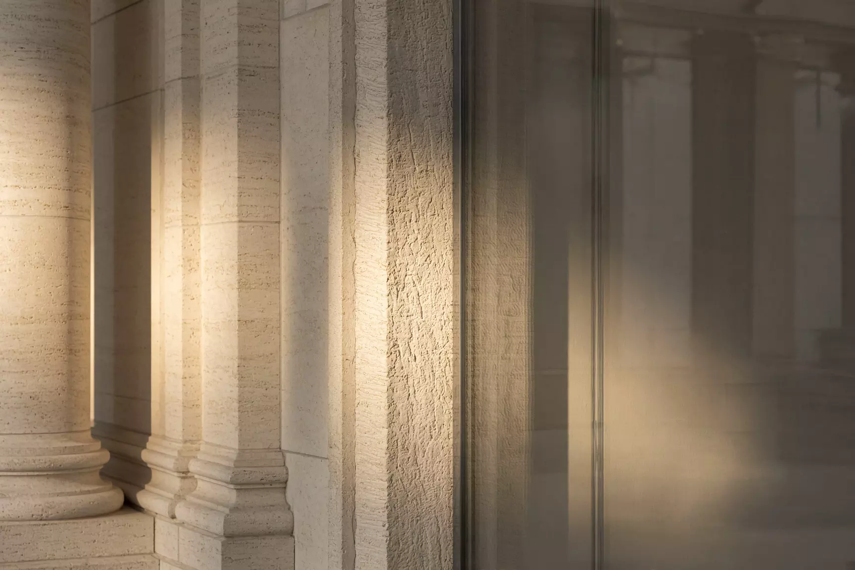 Limestone colonnade and glass in raking light